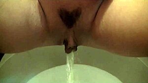 Chick masturbates on toilet then sucks gloryhole cock