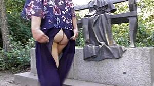 Hairy mature woman flashes her pussy under skirt at public park.