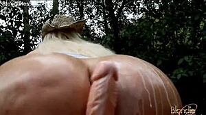 cowgirl rides big dildo while oiling her body in the forest