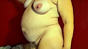 preggo milf slowly strips off her clothes, craving a hard fuck