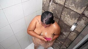 Watch her fingers tease that juicy pussy in the steamy shower