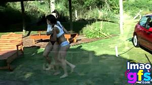 two hot brunettes naked in the carwash showing off big tits and perfect ass