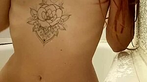 Explore a captivating redhead teen 18+ indulging in a soothing bath with indian shower elements and tattoos