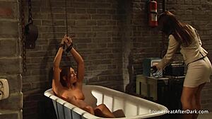 Bound slave finds pleasure under mistress's guidance.