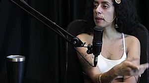 Safada shows off chest tattoos after saying she values small achievements, likes fingering ass, slaps, and blowjobs - Bibi Hourani watch on sheer red.