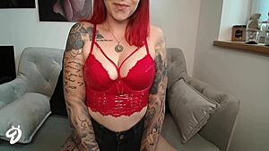 red fetish outfit with pierced nipples and tattoos on young european redhead