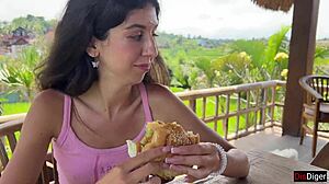 cute girl eating burger with cum on her face in public cafe - cumwalk 😋