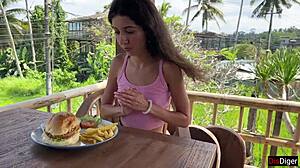 cute girl eating burger with cum on her face in public cafe - cumwalk 😋