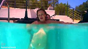 Underwater, two lesbians strap on and fuck passionately