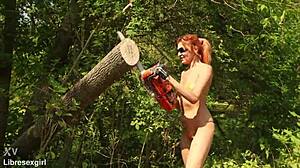 sawing wood in a bikini outdoors in forest