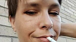 kelly kendricks smokes cigarettes in the sun with lots of cleavage