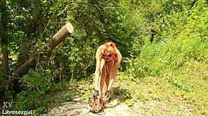 sawing wood in a bikini outdoors in forest