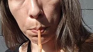 kelly kendricks smokes cigarettes in the sun with lots of cleavage