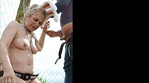 Farm slave performs outdoor tasks in submissive role