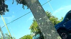 girl fixes sports bra in gym parking
