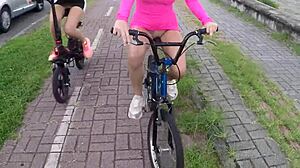 Two beauties cycle without panties in rain