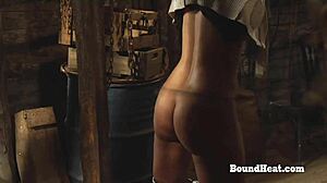 sensual tight lesbian slave moans loudly as madame fingers and kisses her bound body