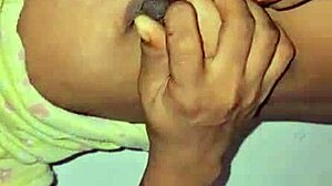 The deshi bhabi was playing with her big boobs at home