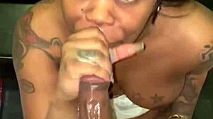 She's sucking that big black cock in front of the fridge, sloppy and deep