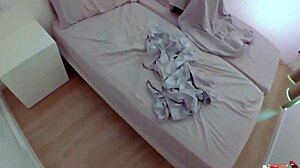 The sexy stepmom shares the bed with her stepson, masturbating right next to him.