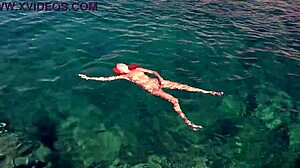 Skinny babe flashes shaved wet pussy by blue water outdoors!