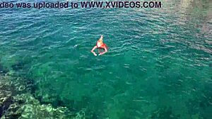 Skinny babe flashes shaved wet pussy by blue water outdoors!