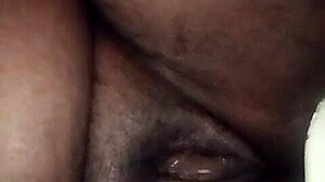 dark juicy folds glisten inviting deep exploration of black pussy depths