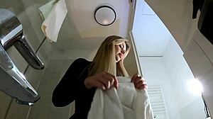 hey check out this big tits blonde in heels and pantyhose stripping her miniskirt off in the bathroom