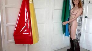 Redhead milf in pvc apron fingers shaved pussy to explosive squirting orgasm frenzy