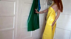 Redhead milf in pvc apron fingers shaved pussy to explosive squirting orgasm frenzy