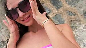 cute brunette babe chills in bikini flashing at public beach