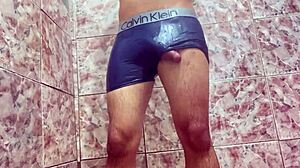 young guy teases huge bulge under shorts outdoors