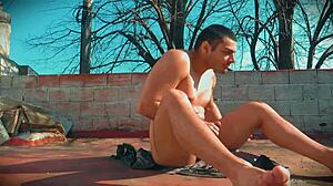 muscular bodybuilder's monster cock sunbathing outdoors