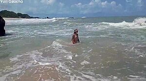 yuri gaucho wife struts her curves on nudist beach as crowd goes wild for every jiggle