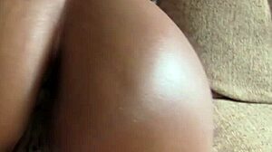 natural big-titted ebony babe drops to knees for agent's throbbing cock on sofa