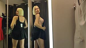 Blonde wife flashes big tits in see-through lingerie at mall changing room.