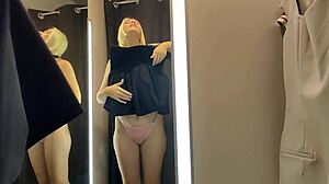 Blonde wife flashes big tits in see-through lingerie at mall changing room.