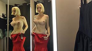 Blonde wife flashes big tits in see-through lingerie at mall changing room.