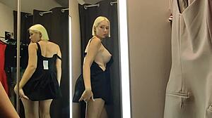 Blonde wife flashes big tits in see-through lingerie at mall changing room.