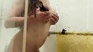 asian ladyboy grinds her monster cock against shower glass in solo tease.