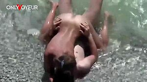 amateur couple sneaks quick fuck in ocean waves on crowded public beach