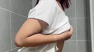 She dances while groping her own tits in teasing solo display