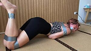 Redhead's Sexy Feet Exposed While Bound and Duct-Taped Tight