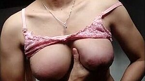 Shemale Mitha Waria strokes her cock in pink bra and stockings till she explodes cum everywhere