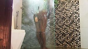 ebony milf slips into shower with new toy and someone peeks in curiously