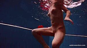 sexy tight-pussy teen avenna dives naked into the pool showing off her shaved nude twat underwater