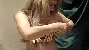 French slave housewife bound in handcuffs and chains for auto bdsm session with clamps and submission belt