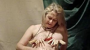 French slave housewife bound in handcuffs and chains for auto bdsm session with clamps and submission belt