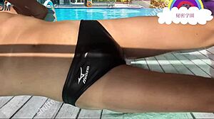 Schoolgirl slips into latex swimsuit for secret pool handjob fetish outdoors