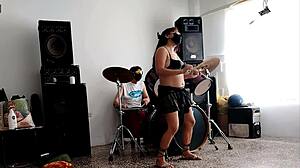 She drums wildly then strips teasing her huge curvy ass for neighbors